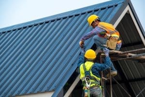 roofers working on metal roof