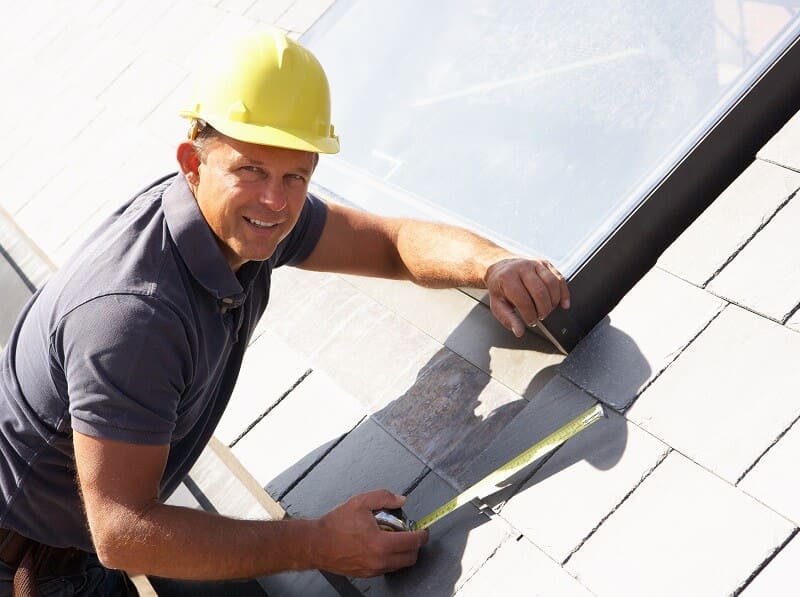An experienced roofer on a roof